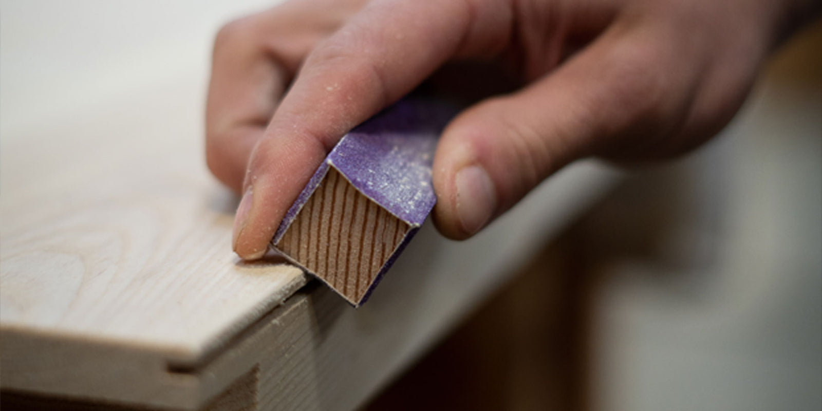 Craftsman' hand sanding a door bottom edge