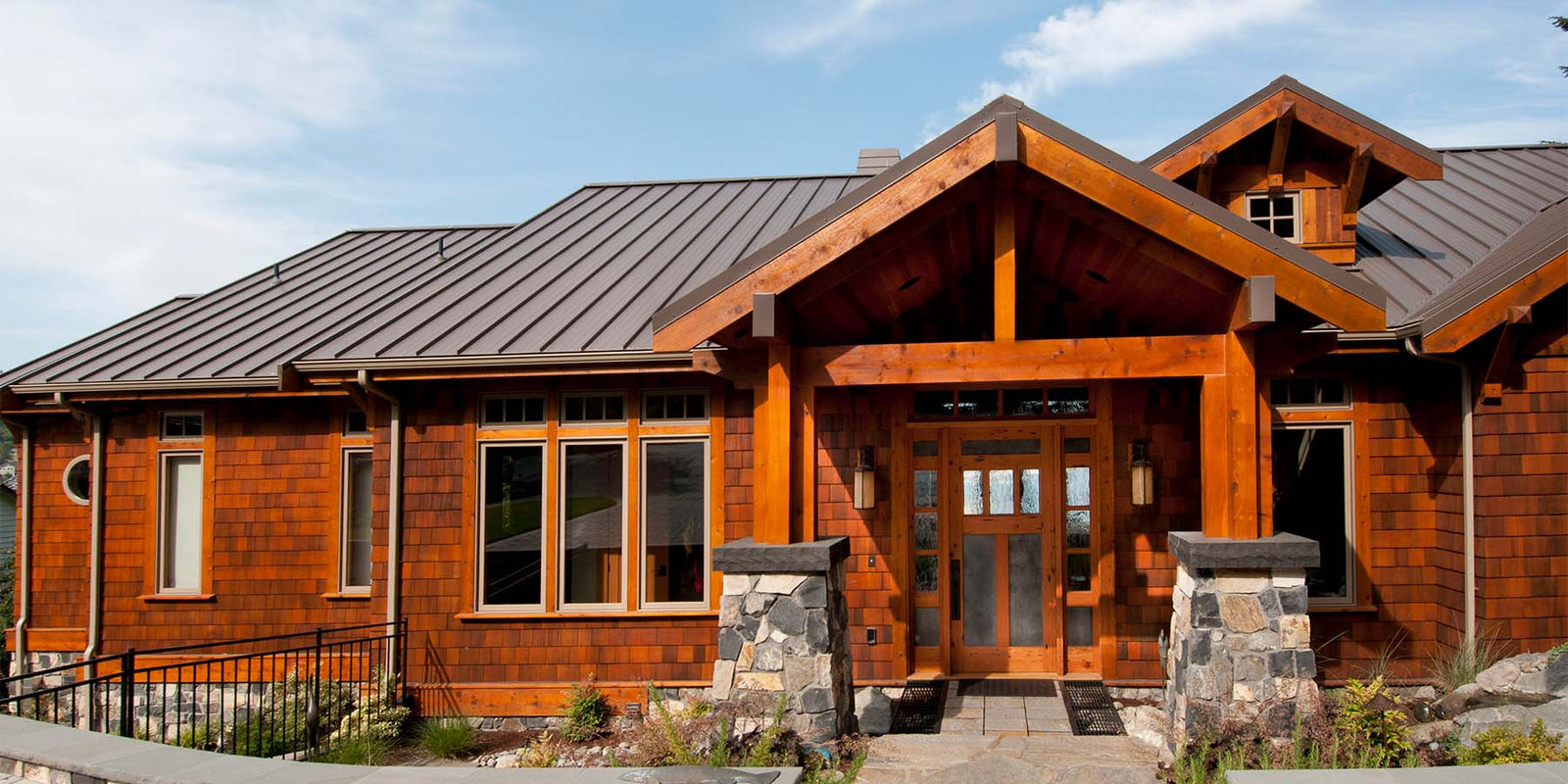 Custom wood front door with a long overhang