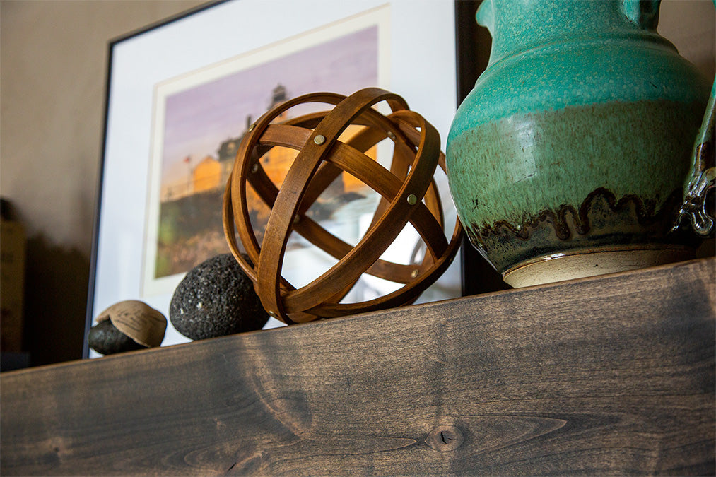 Green vase and Knick knacks on a fireplace mantel