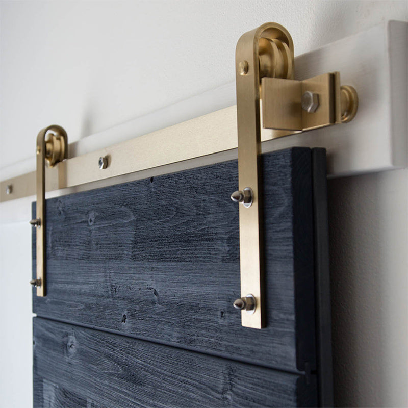Solid Brass Flat Track Barn Door Hardware installed on blue weathered wood door