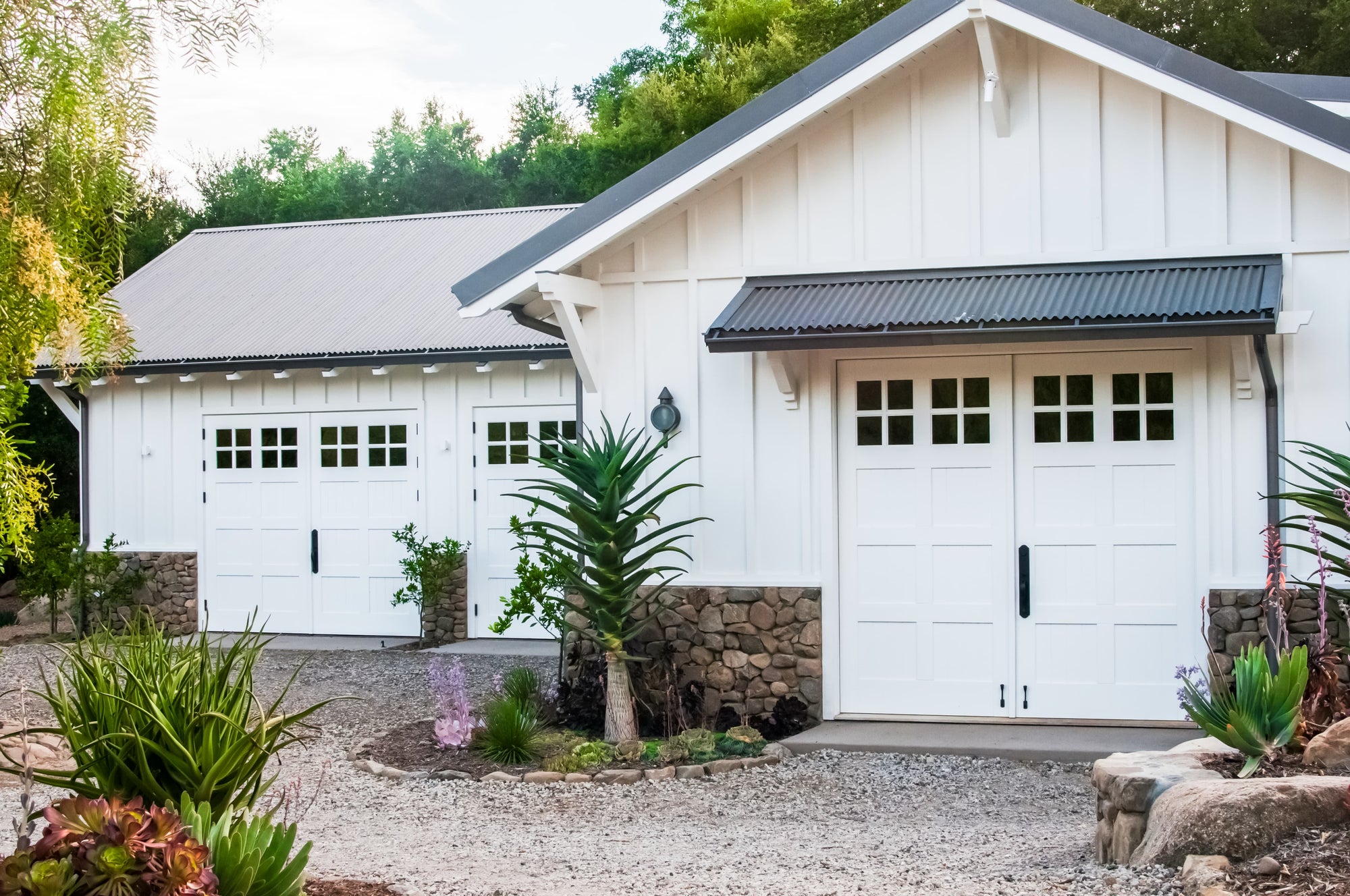 Three white carriage door sets on patio area