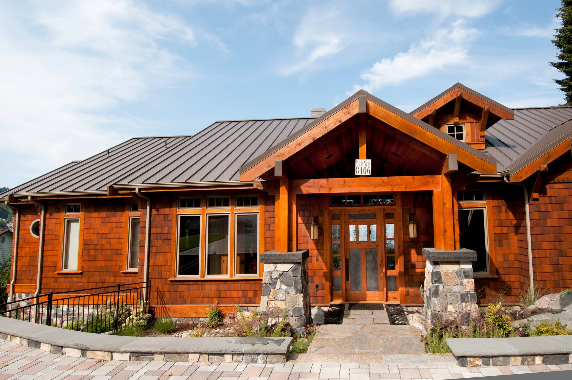 Custom wood front door on large brown residence