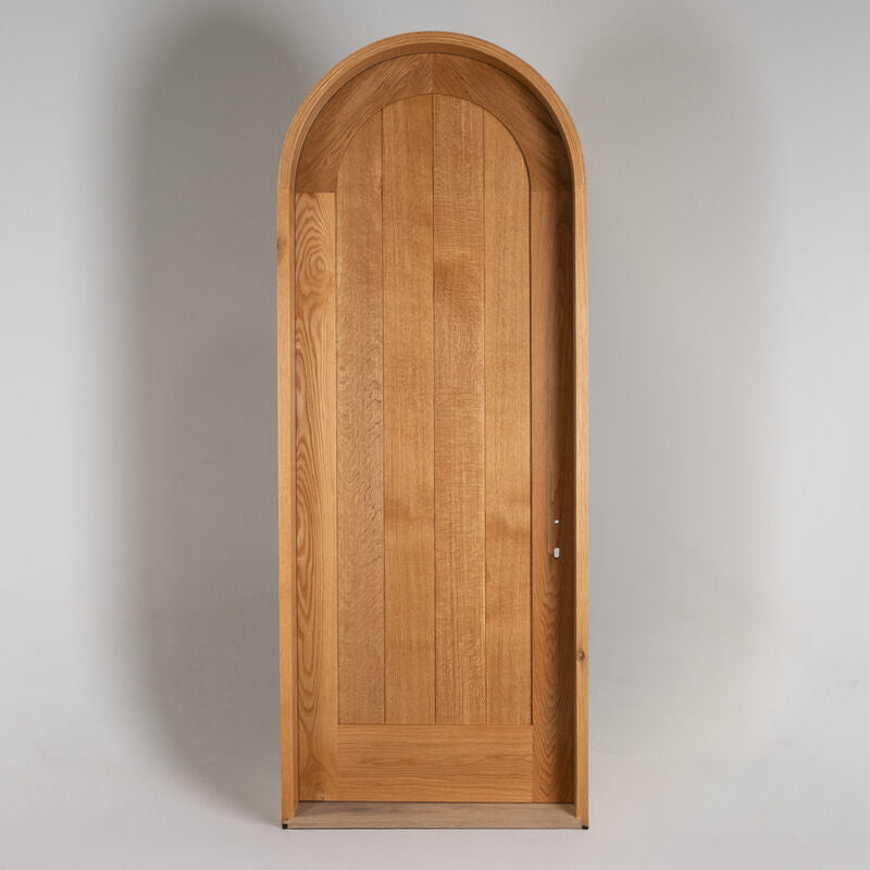 A pre-hung Round Top Door against a studio white backdrop