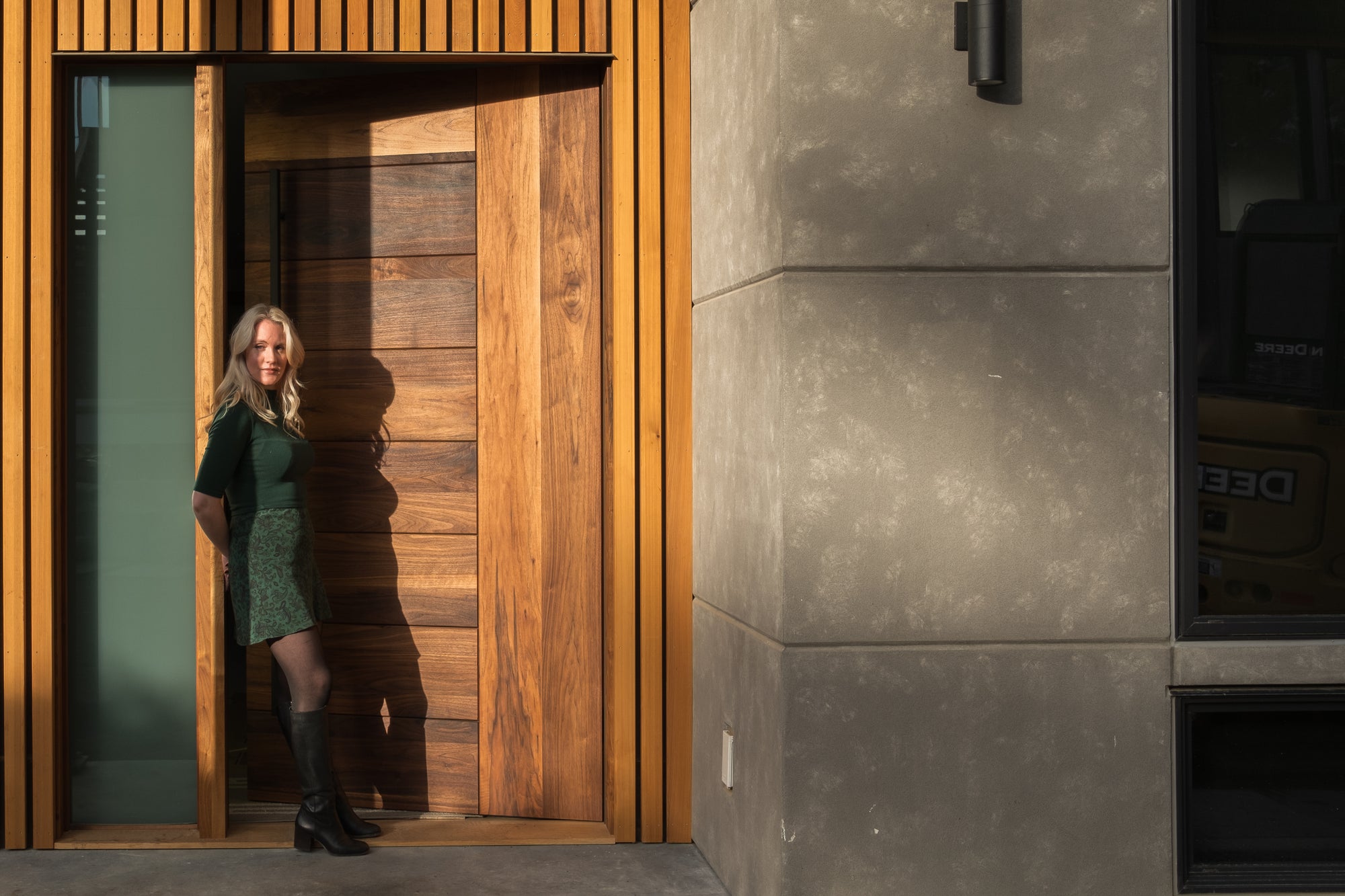 photo of model leaning against the door frame in front of a Peninsula door