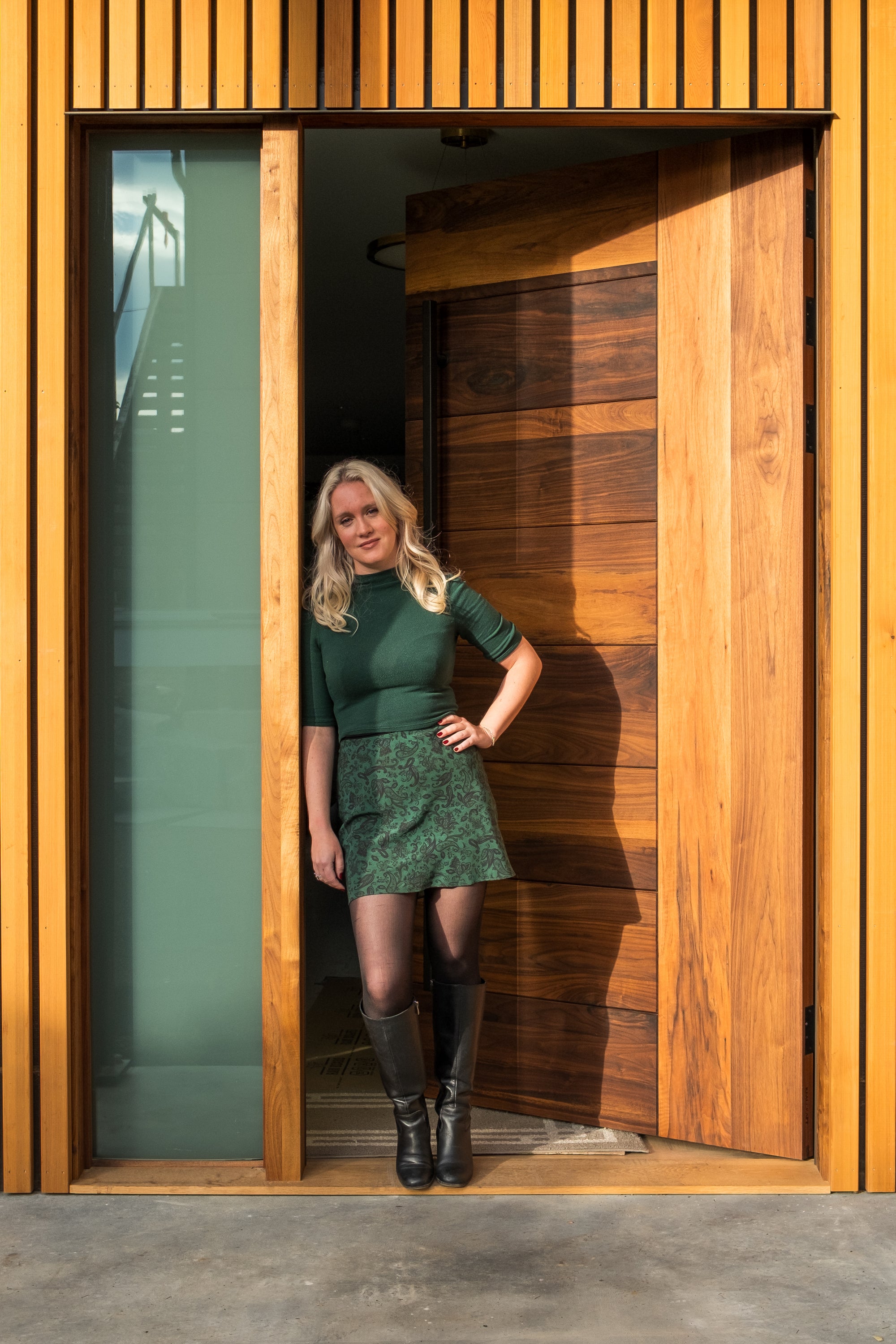 photo of model in green standing in front of Peninsula Door