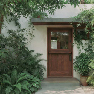 Wooden dutch door of a house surrounded by greenery