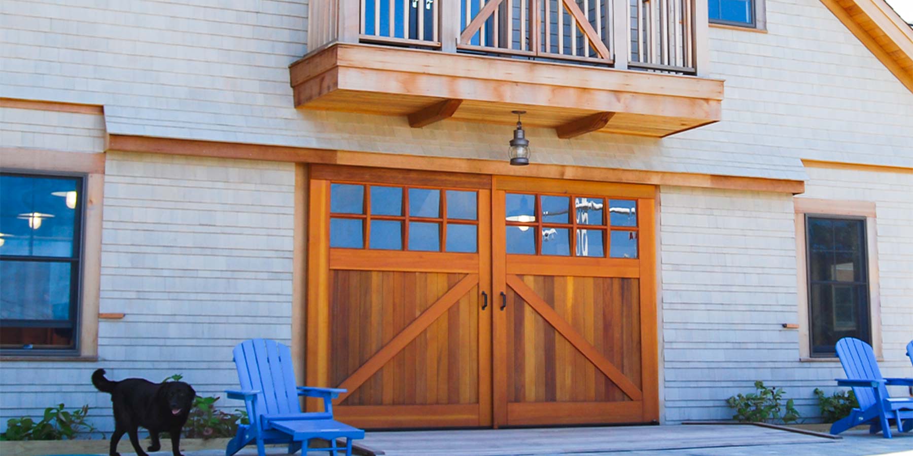 Exterior sliding barn door with glass panes on beach house