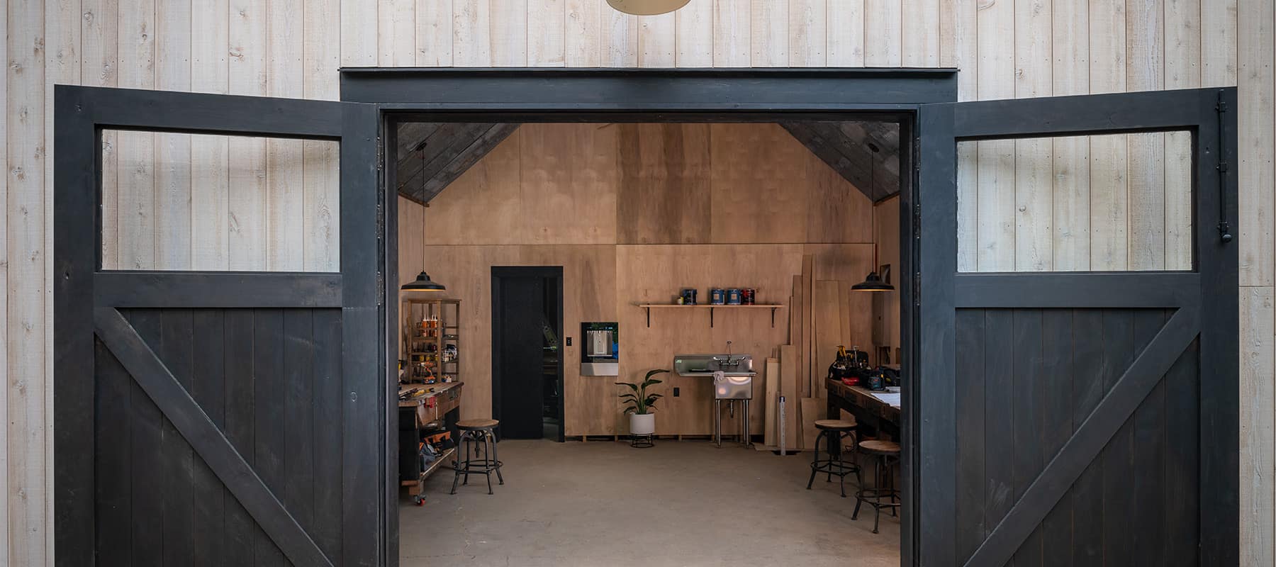 Open black carriage doors with top glass