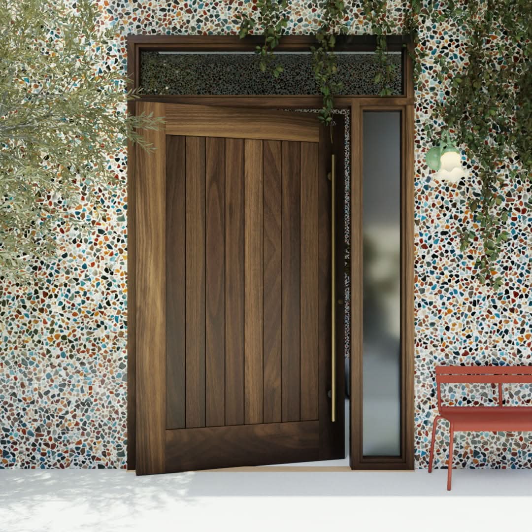 Monterey Single Panel Tongue and Groove Pivot Door with sidelights and transom and a long brass handle in a colorful garden wall