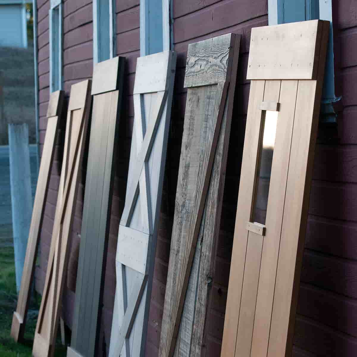 Six Barn doors against a barn