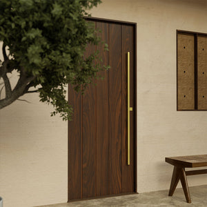 Contemporary walnut wood front door with clean plank lines and modern brass handle, set against a stucco entryway.