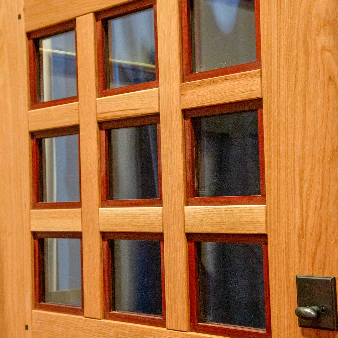closeup photo of nine glass panels with White Oak mullions and Padauk contrast sticking