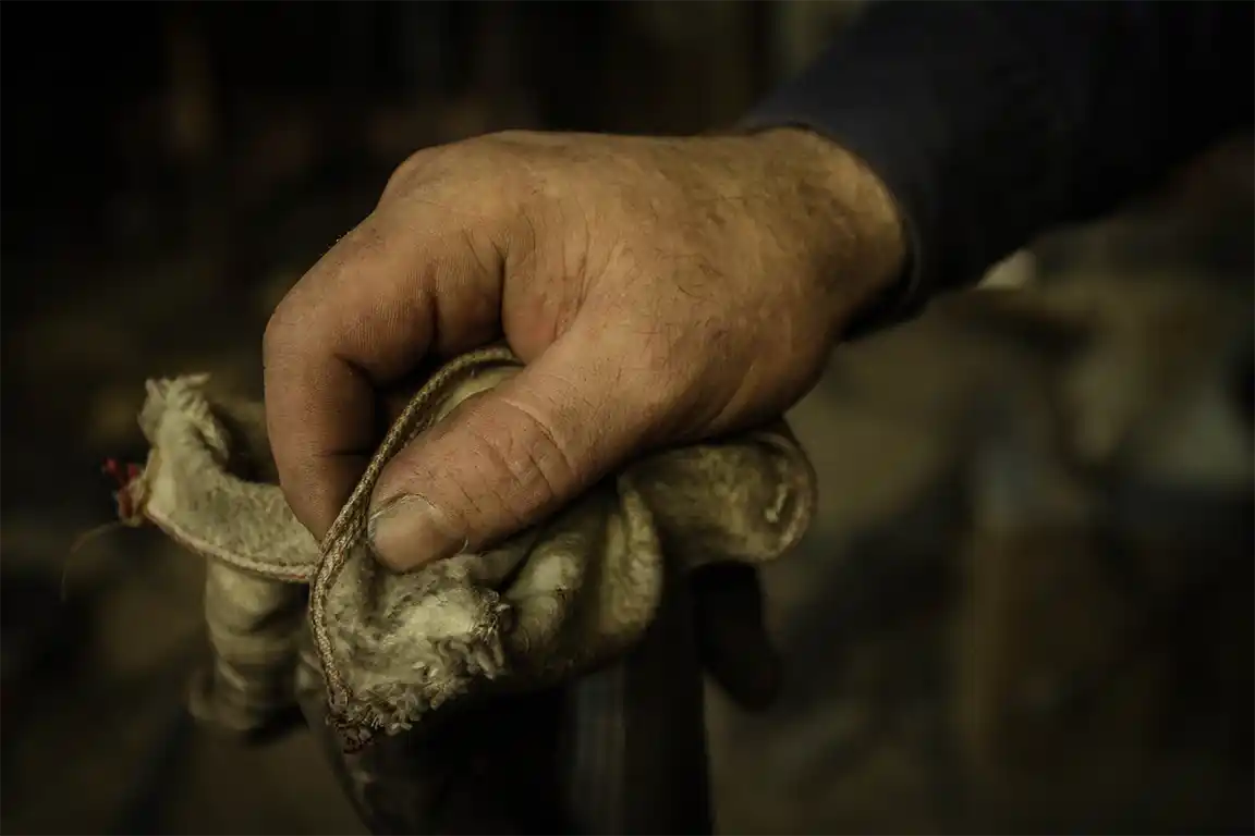 Blacksmith hand holding a cloth