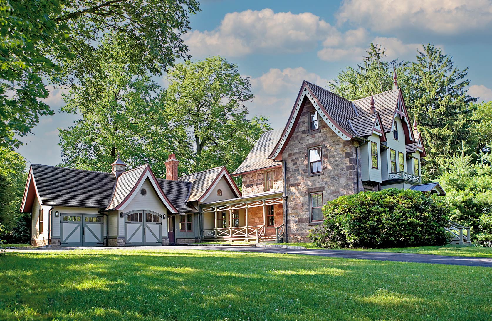 Large house with two sets of green carriage doors