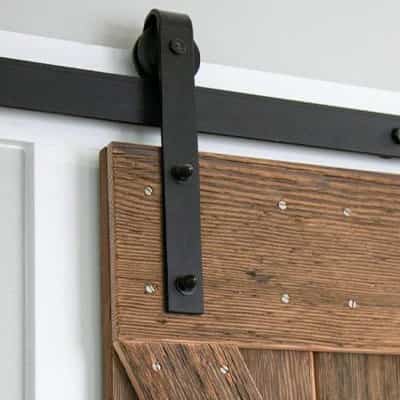 Black barn door kit on rustic door