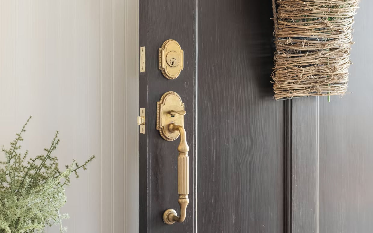 Emtek Knoxville Door Handle shown on dark entry door with deadbolt