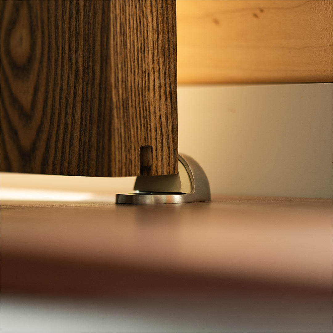 steel door stop against the edge of a wood door