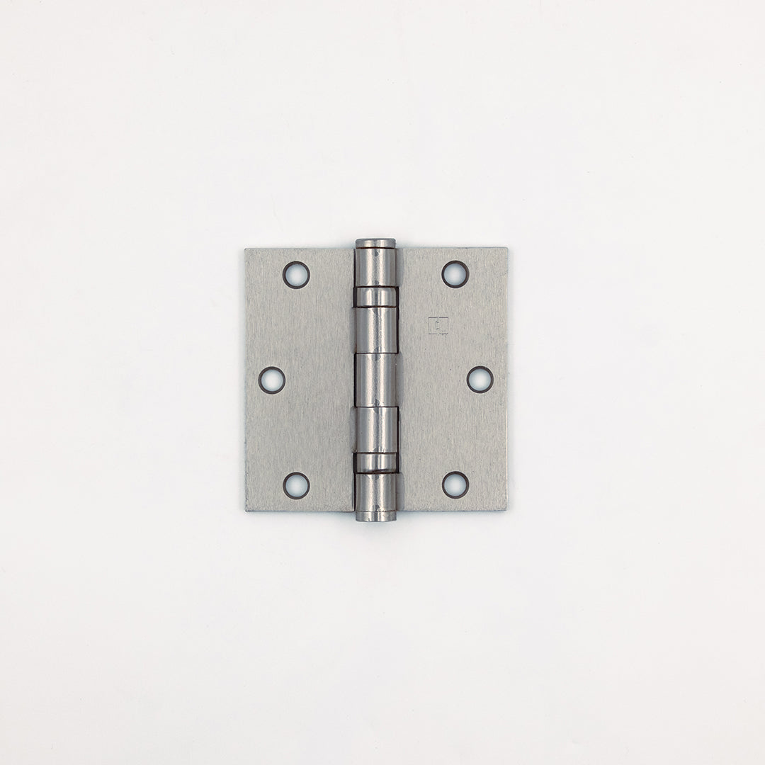 Metallic door hinge on a white background