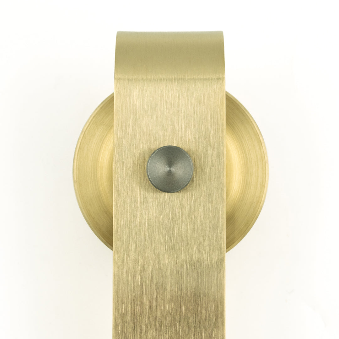 Brass sliding door hanger on a white background