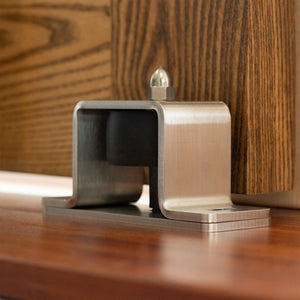 Stainless Steel Industrial Heavy-Duty Barn Door Floor Guide Roller installed on a oak door