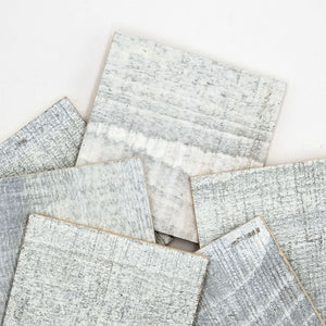 Modern Kitchen with gray cabinets and a gray reclaimed wood accent wall