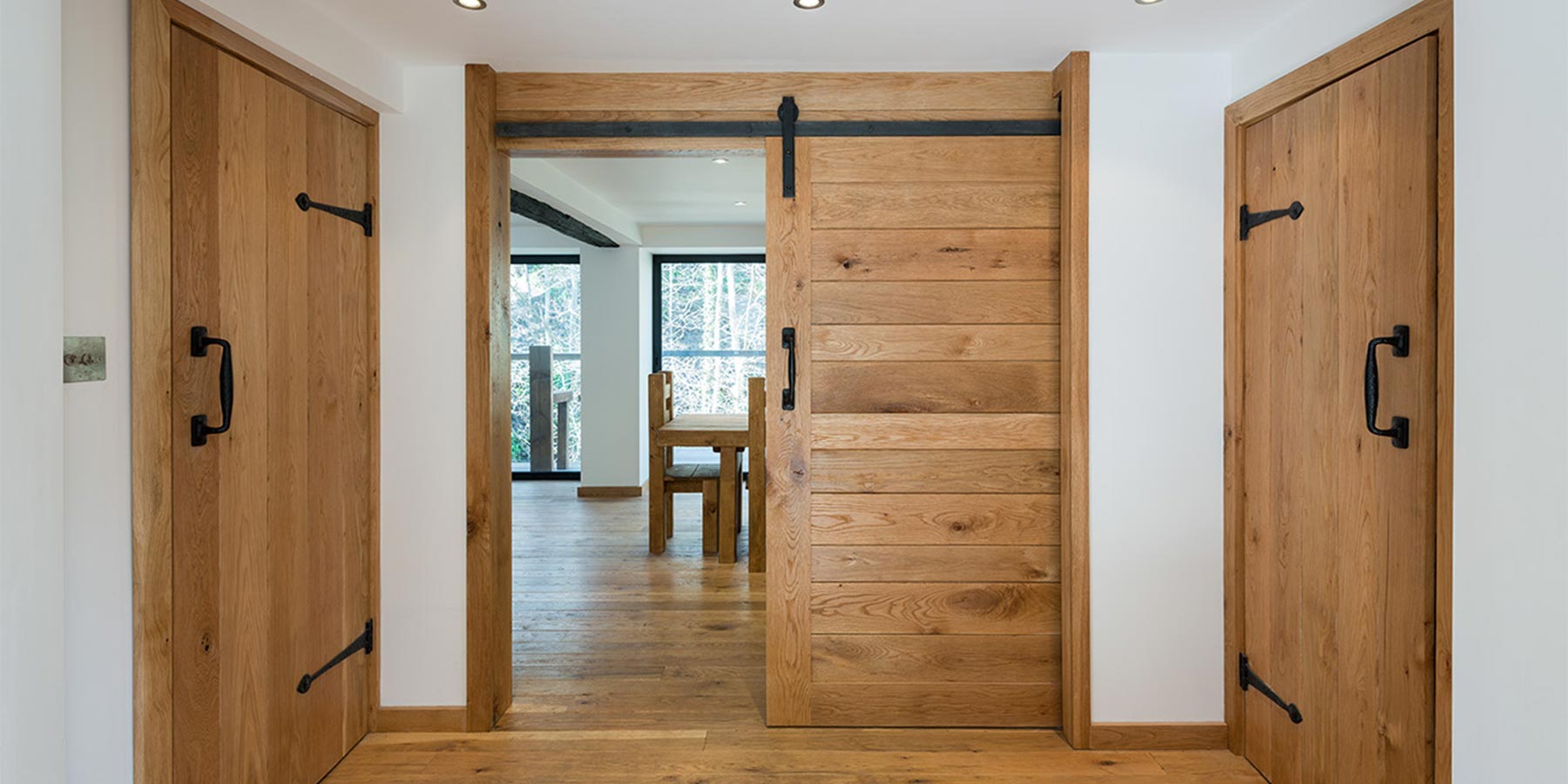 A pocket door semi open between two regular doors