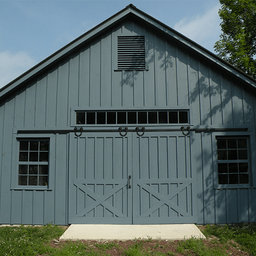 Double green exterior doors installed on a barn