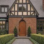 Traditional brick house with wooden Saepele Archd door and garden