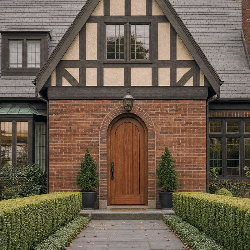 Traditional brick house with wooden Saepele Archd door and garden
