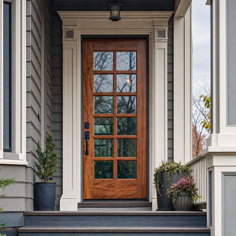 Wooden front door with glass panels on a house exterior