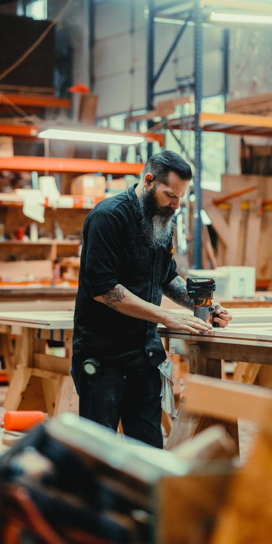 Craftsman cutting wood at the wood shop.