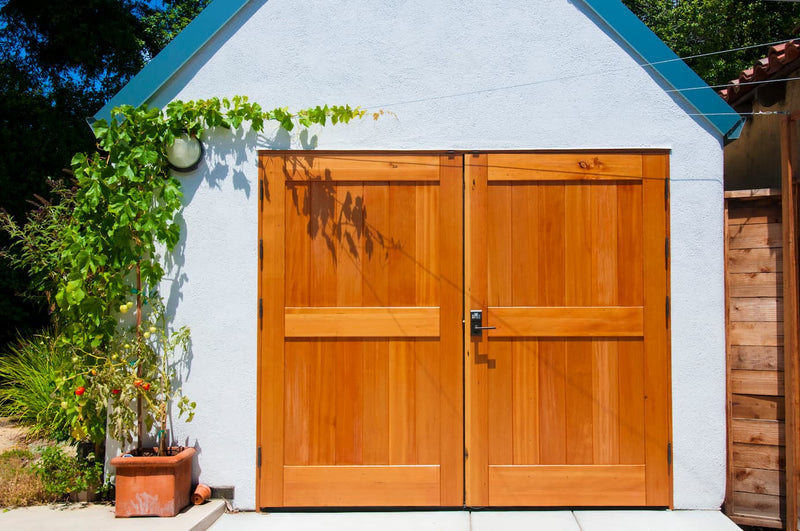 Simple solid wood carriage door on patio area