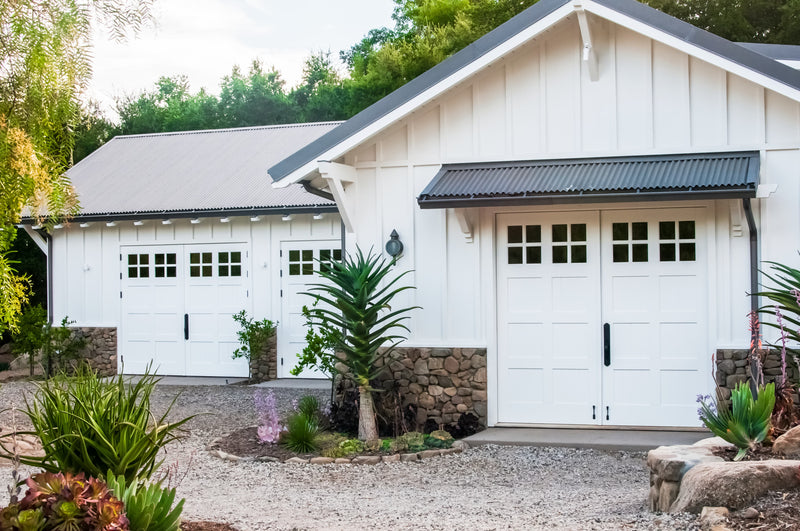 Three white carriage door sets on patio area