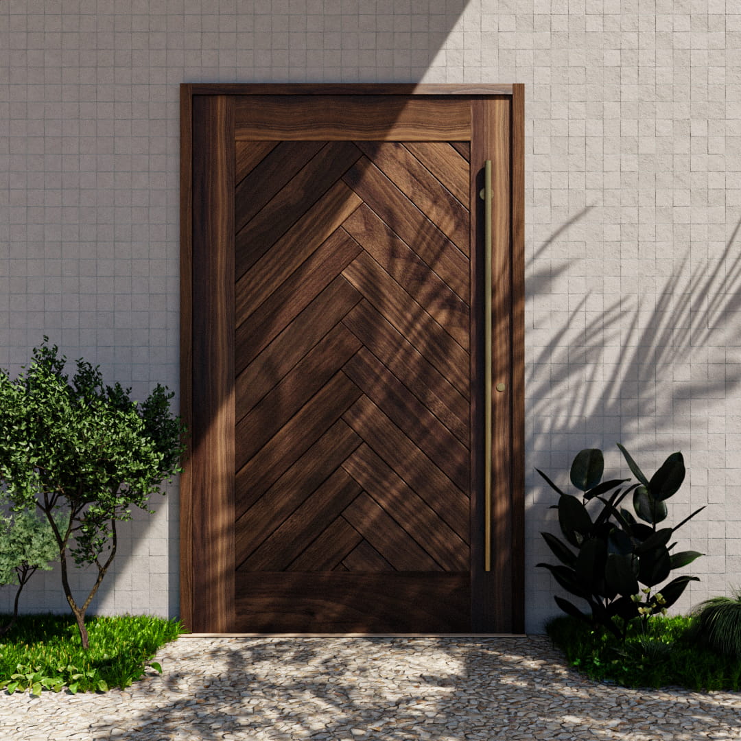 Montauk Herringbone Pivot Door with sidelights and transom and a long brass handle in an exterior patio next to plants