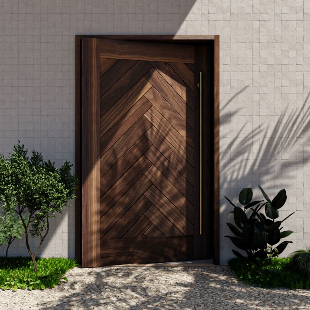 Montauk Herringbone Pivot Door with sidelights and transom and a long brass handle in a white title wall