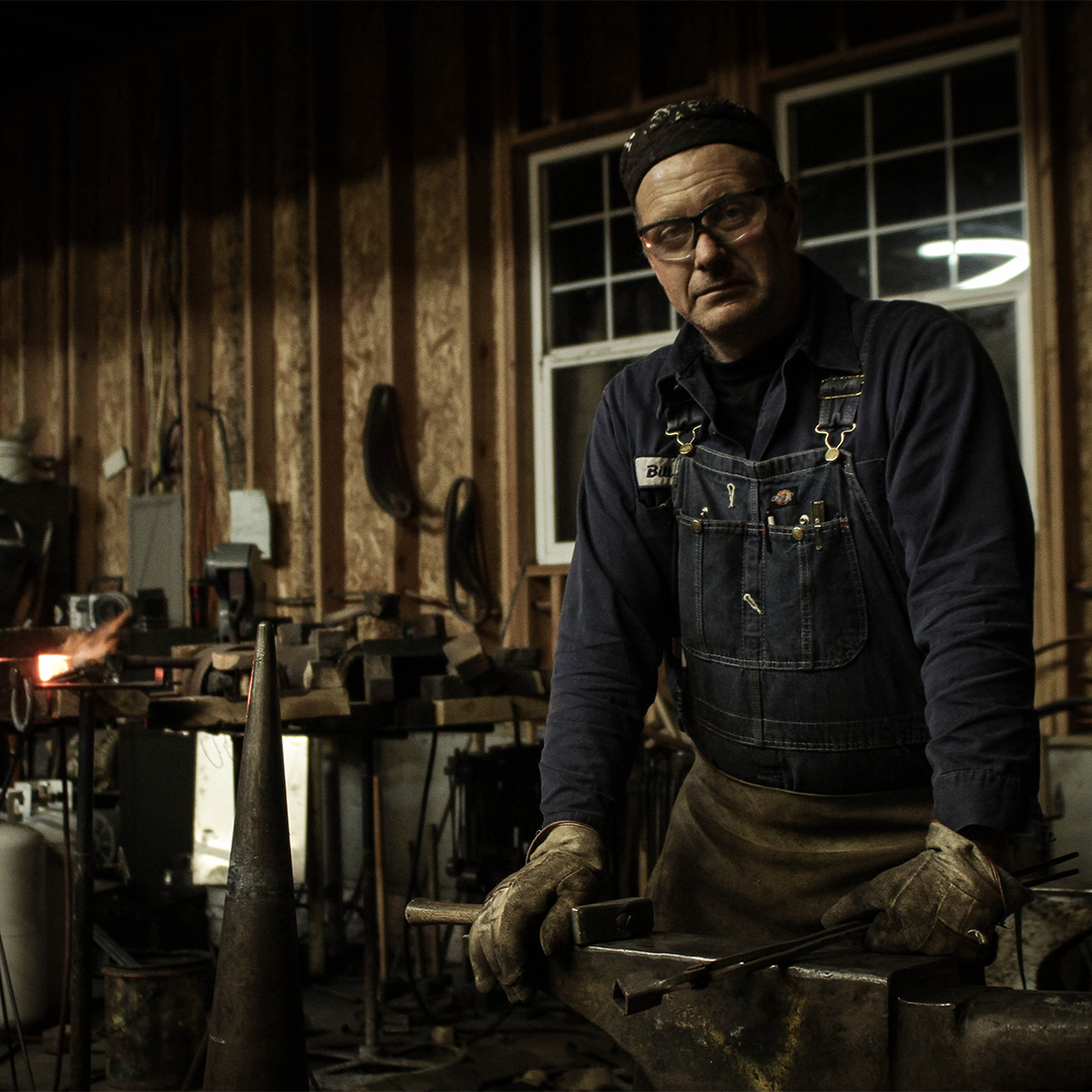 RealCraft's blacksmith posing at the metal shop