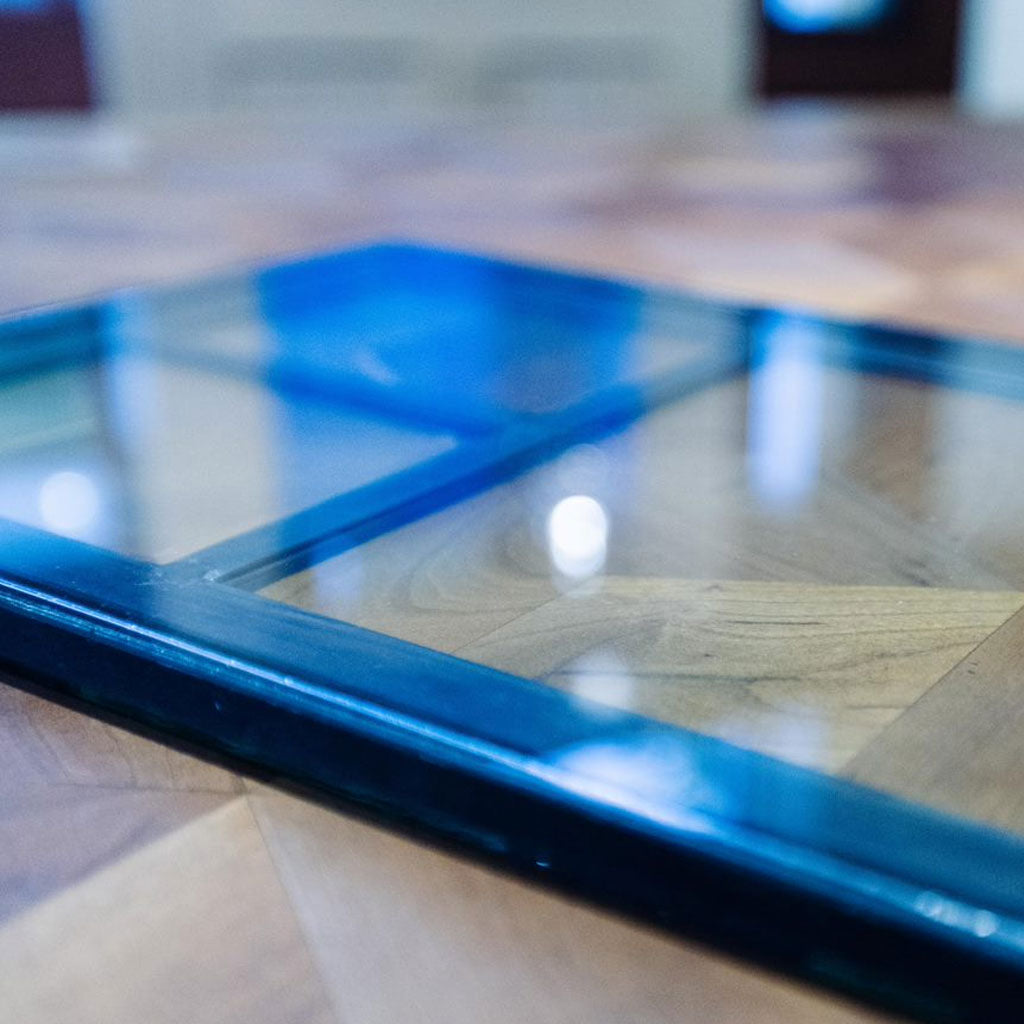 Custom insulated glass window sample on a wood table