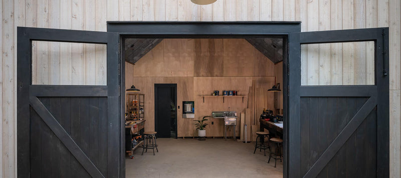 Open black carriage doors with top glass