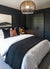 Luxury bedroom with black double barn doors by RealCraft.