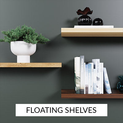 Three wood floating shelves on a green wall