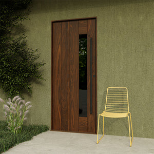 Walnut mid-century modern front door with slim side window and clean plank design, styled with outdoor chair and greenery.