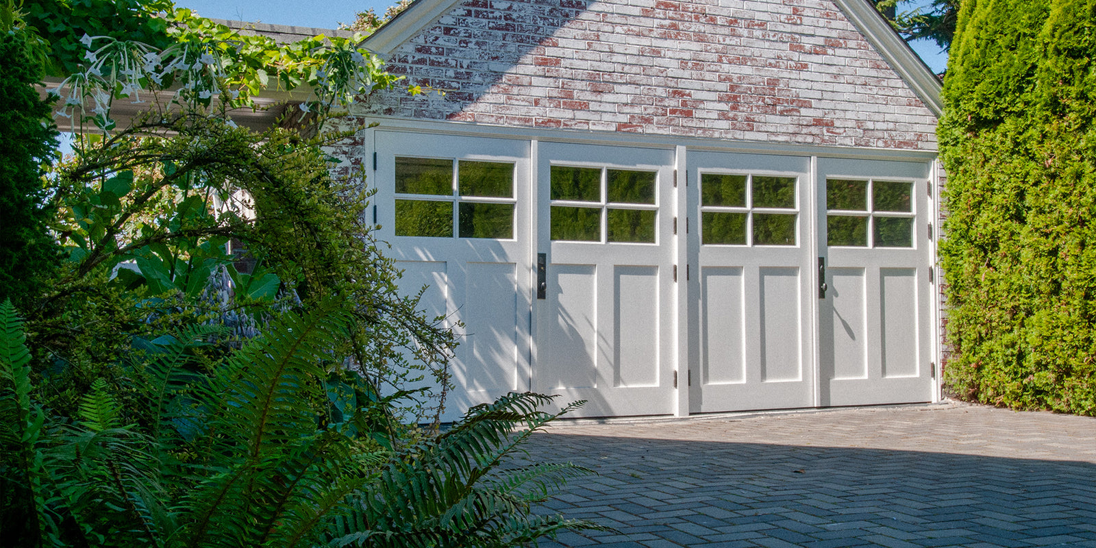 White carriage doors on brick facade