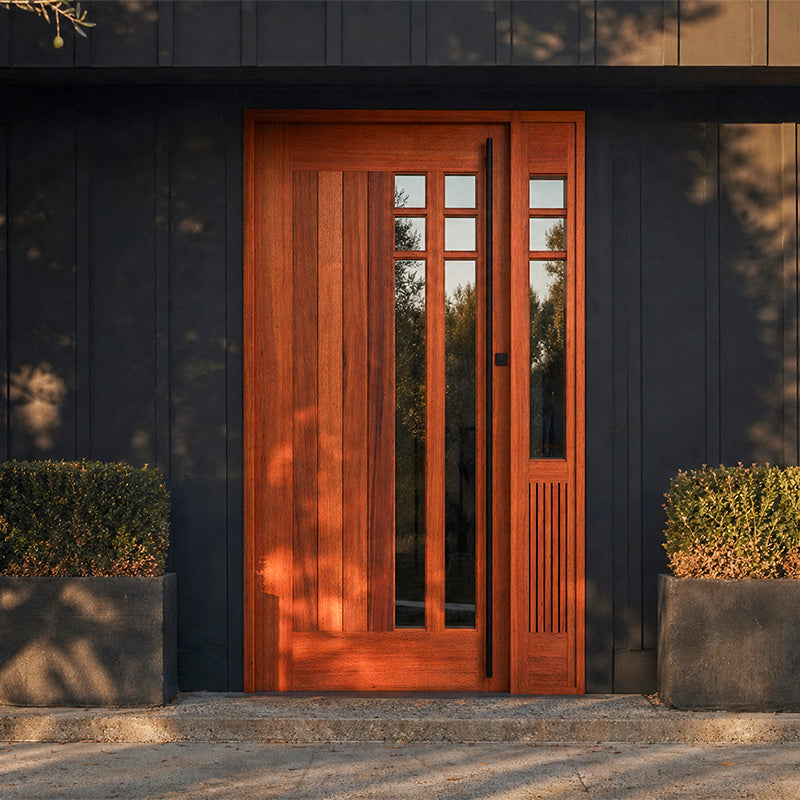 Mid-century modern Wooden door with glass panels on a dark building exterior