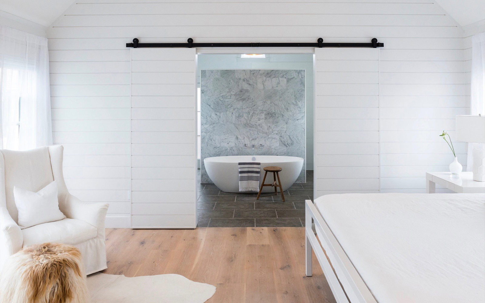 biparting white barn doors with black hardware