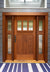 Sapele Mahogany craftsman style entry door with sidelights on  blue house