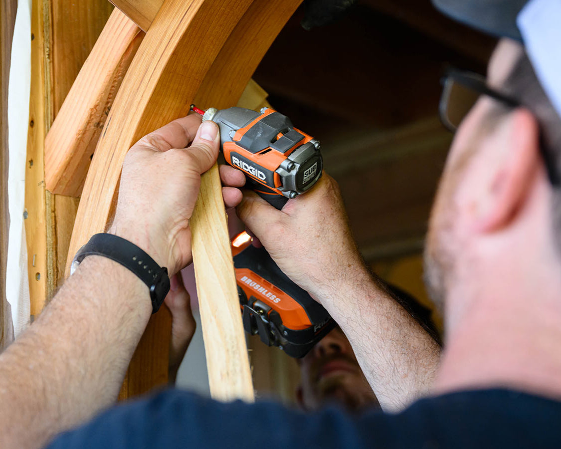 closeup of craftsman screwing door frame in place