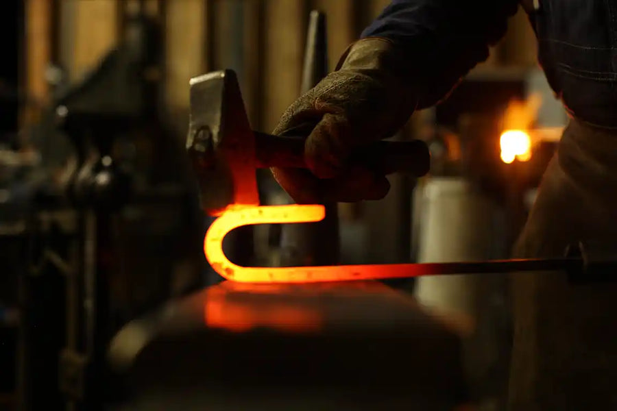Blacksmith hammering barn door hardware