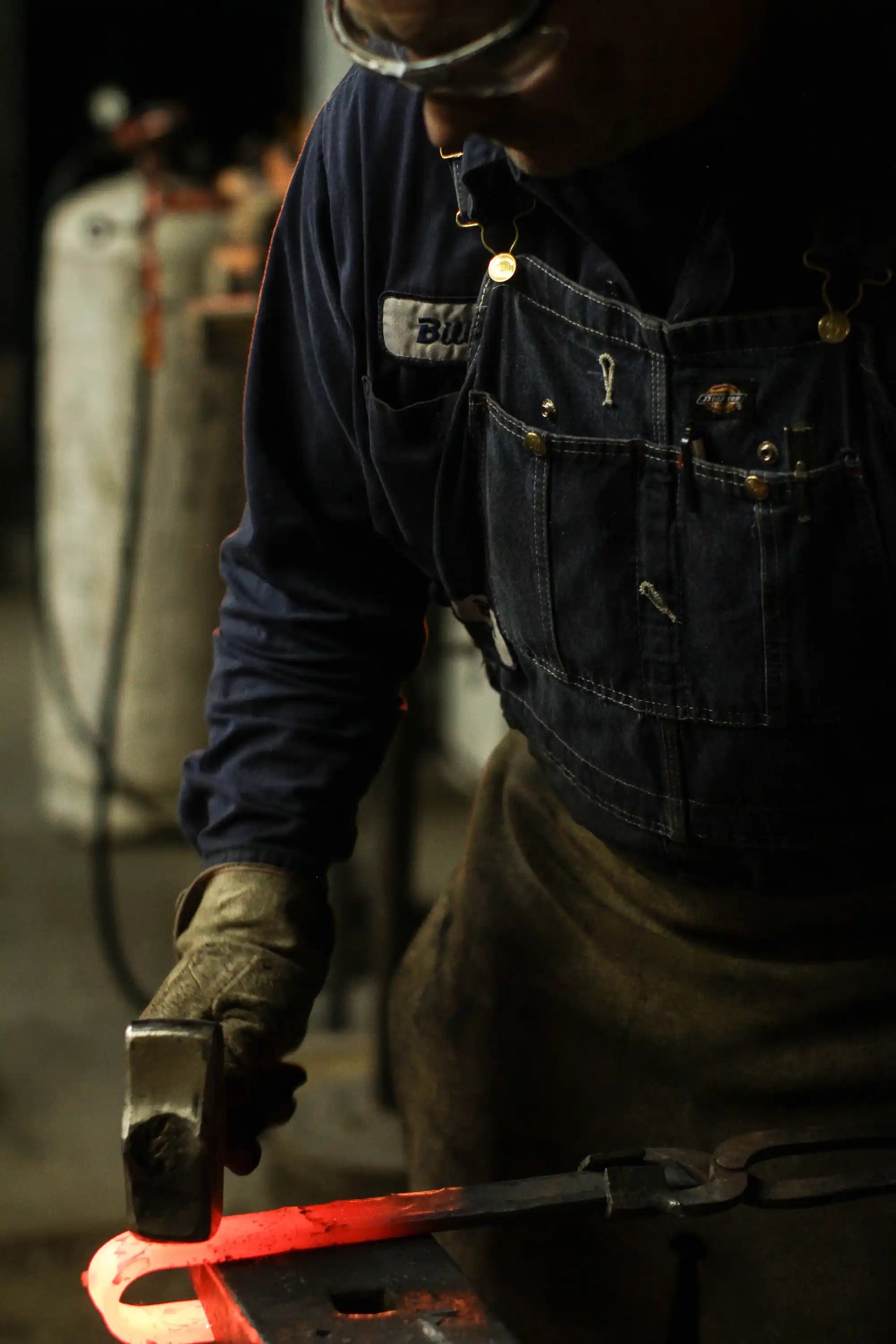 blacksmith hammering barn door hardware