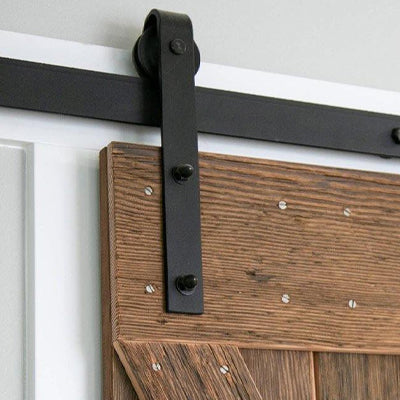 Classic Flat Track Sliding Hardware kit in Black Finish Installed on the weathered door.