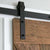 Black barn door kit on rustic door